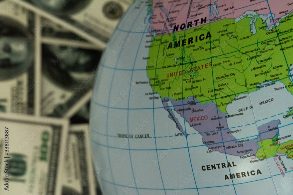 Globe lying on the background full of money Globe lying on the background full of money