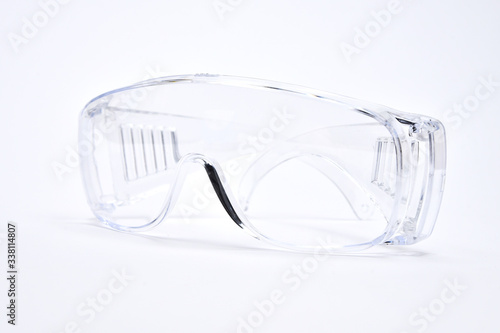 Protective transparent plastic eyeglasses on white background