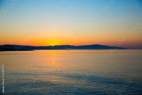 beautiful scenic sunset on the beach. Rocks and sea. © Cumhur