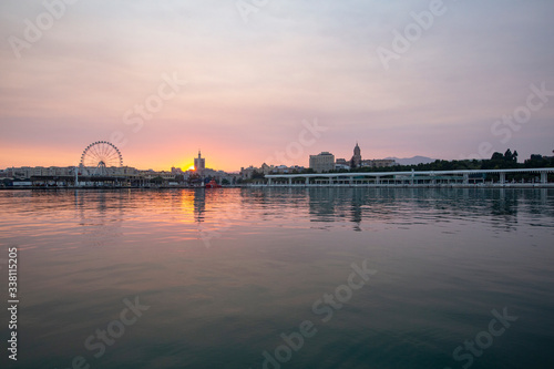 sunset landscape with the sea and buildings in the background © MiguelAngel
