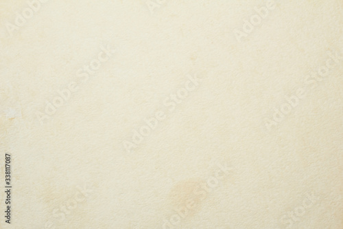 Old vintage beige sheet of drawing paper with dirty stains and spots on surface texture background.