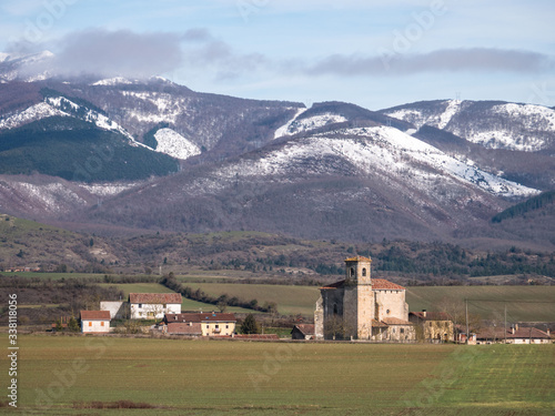 View of the village of Ordañana and the Aizkorri mountain range, Alavese Plains near Salvatierra, Basque Country, Spain photo