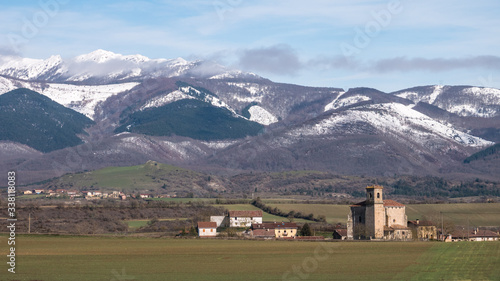 View of the village of Ordañana and the Aizkorri mountain range, Alavese Plains near Salvatierra, Basque Country, Spain photo