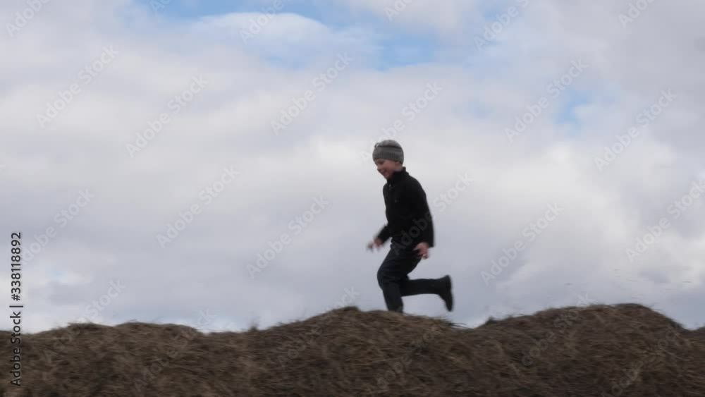 child play with a stack of straw against the sky child play with a stack of straw against the sky