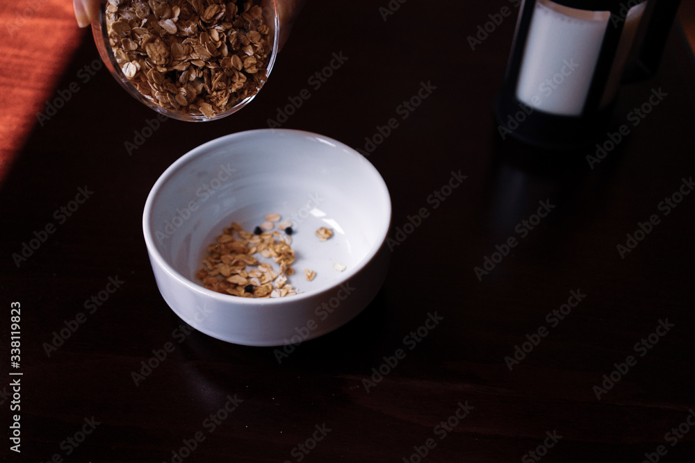 Pouring the oatmeal into the white porcelain bowl standing on wooded table.
pouring oatmeal for breakfast in a white porcelain oatmeal bowl. preparing for the breakfast with oatmeal. Pouring the oatmeal into the white porcelain bowl standing on wooded table.
pouring oatmeal for breakfast in a white porcelain oatmeal bowl. preparing for the breakfast with oatmeal.
