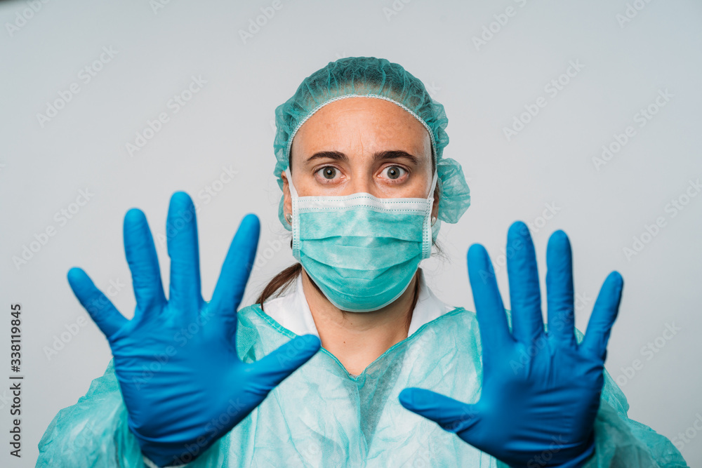 Young woman stop hand gesture, wearing medical mask protect herself from coronavirus, medical and health concept. Young woman stop hand gesture, wearing medical mask protect herself from coronavirus, medical and health concept.