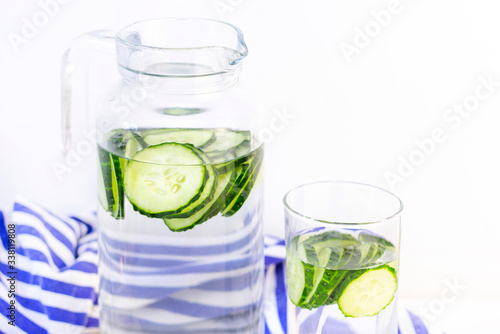 Health care, fitness, healthy eating concept. Fresh cool.cucumber drink with water, cocktail, detox drink, lemonade in a glass jug and a glass.