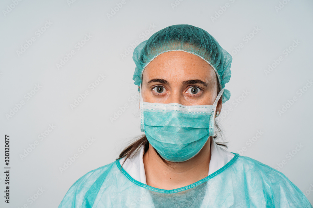 COVID-19 Coronavirus pandemic happy doctor positive with hope wearing surgical mask and protective scrubs at hospital. Inspiring confidence in the future to solve the crisis. COVID-19 Coronavirus pandemic happy doctor positive with hope wearing surgical mask and protective scrubs at hospital. Inspiring confidence in the future to solve the crisis.