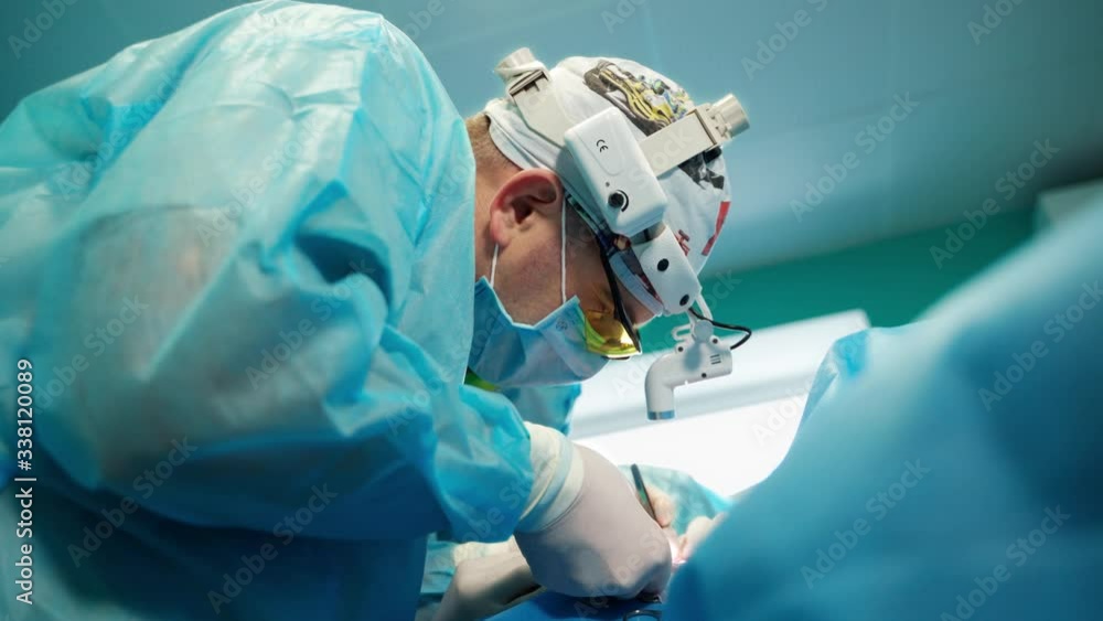 Plastic surgery. Medical procedure to a patient in clinic. Professional surgeon in medical uniform performing an operation together with a nurse. Close-up. Plastic surgery. Medical procedure to a patient in clinic. Professional surgeon in medical uniform performing an operation together with a nurse. Close-up.