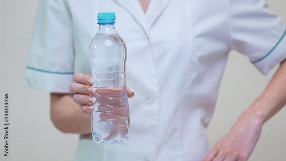 female woman nutritionist or dietician doctor healthy lifestyle concept - holding bottle of water female woman nutritionist or dietician doctor healthy lifestyle concept - holding bottle of water