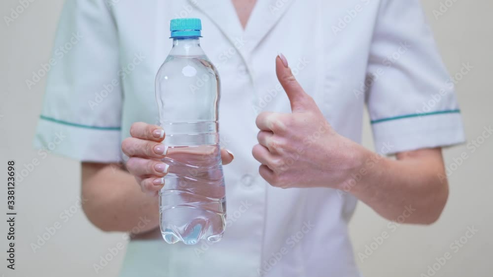 female woman nutritionist or dietician doctor healthy lifestyle concept - holding bottle of water female woman nutritionist or dietician doctor healthy lifestyle concept - holding bottle of water