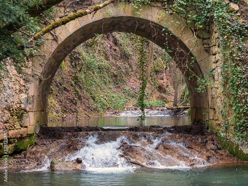 Bridge over the Inglares River next to the Herrerias Waterfall near Berganzo, Alava, Basque Country, Spain photo