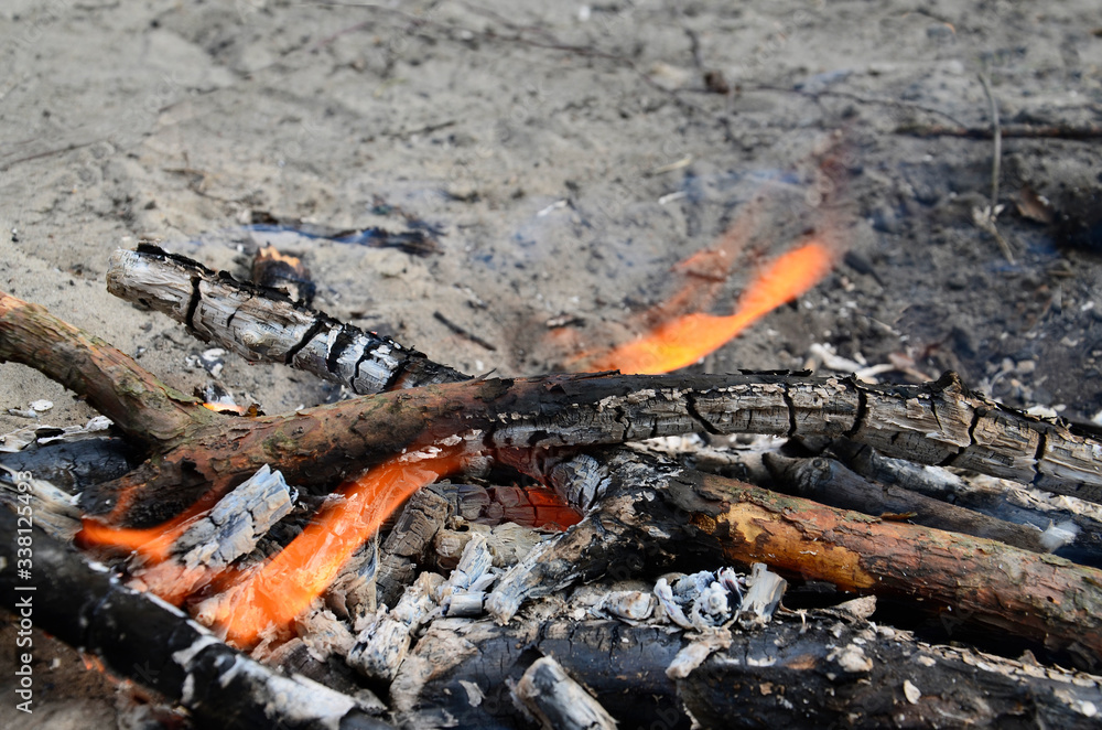 The fire is burning down. Burnt wood, ash. The fire is burning down. Burnt wood, ash.