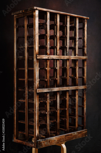 Stand for wine bottles. Wooden wine Cabinet in the wine cellar
