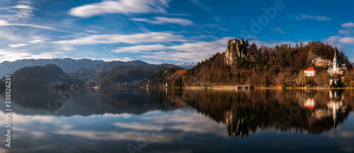 Long exposure panorama shot of the beautiful Lake Bled, Slovenia with the Bled Castle and the surrounding mountains © petertakacs
