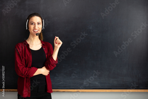 Young woman teacher doing online education in classroom.