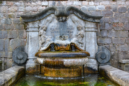 BERCHTESGADEN, GERMANY - Historic town of Berchtesgaden, fountain at the wall photo