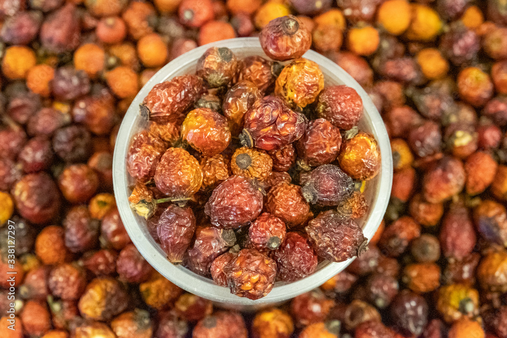 Dried rosehip berries in a box. Large, ripened vegetables. Selling a crop in the market. Natural, healthy, vitamin-rich foods. Food for health. Dried rosehip berries in a box. Large, ripened vegetables. Selling a crop in the market. Natural, healthy, vitamin-rich foods. Food for health.