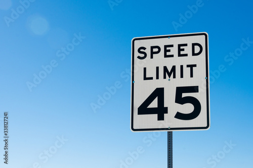 speed limit sign on blue sky photo