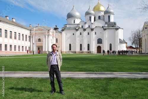 Man walk around Novgorod Detinets (Kremlin) is citadel of Veliky Novgorod, Russia. It stands on left bank of Volkhov River about two miles north of where it empties out of Lake Ilmen. photo