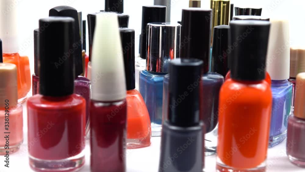 Glass bottles with nail polish of different colors, background Glass bottles with nail polish of different colors, background