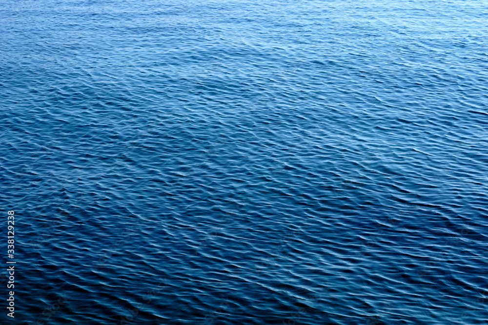 Obraz premium Gradient blue abstract background with the sea water surface on the windy day