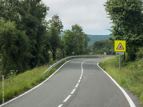 Warning sign showing the minimum distance for passing by cyclists on a curvy mountain pass road