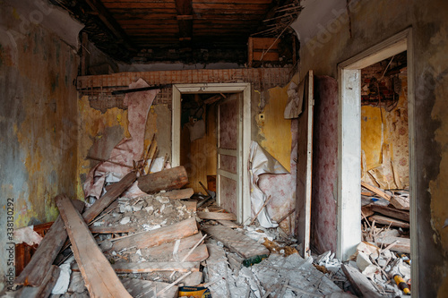 Interior of the ruined collapsed abandoned house © Mulderphoto