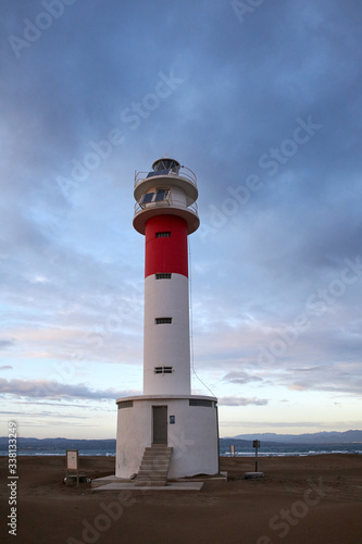 Lighthouse Fangar, in Tarragona, Spain, at sunset © aitorserra