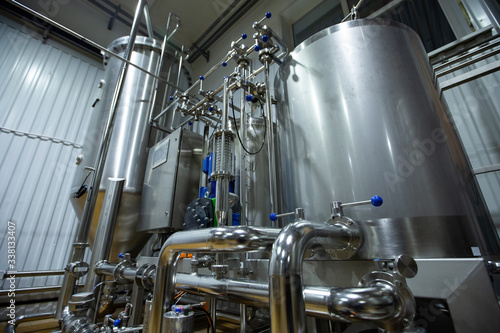 Craft beer brewing equipment in brewery Metal tanks, alcoholic drink production