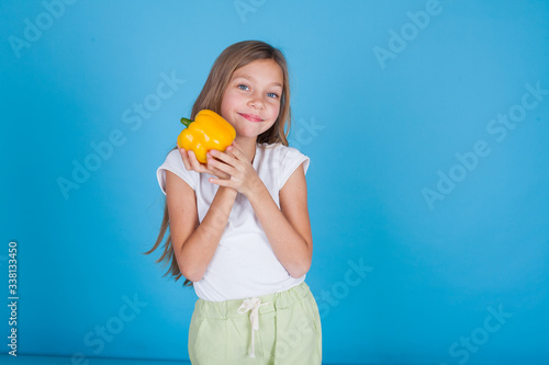 Little girl holds a bell pepper food