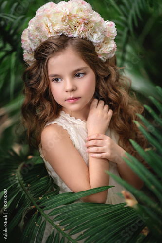 Beautiful girl with flower wreath. Vertical photo