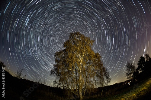 startrails over a pond with trees