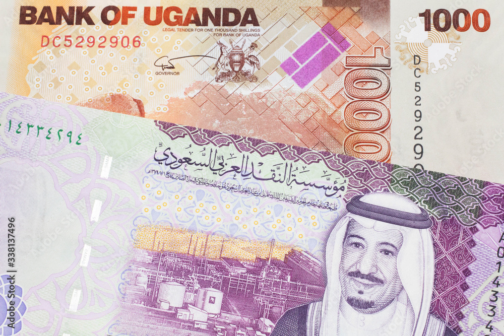 A five riyal note from Saudi Arabia with a one thousand Ugandan ...