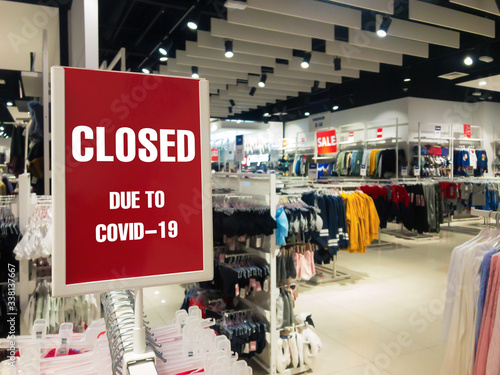 Closed due to covid-19 sign of coronavirus. Information warning text about quarantine in a mall store.