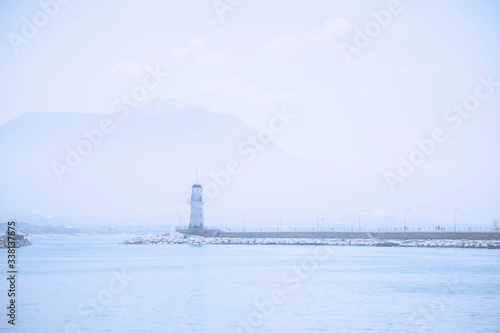 Landscape and lighthouse of Alanya port with Turkish flag, Alanya, Turkey