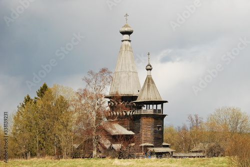 Ancient wooden church of Dmitry Solunsky Myrrh-pouring in the November cloudy evening. Village of Shcheleyki, Leningrad Region, Russia photo