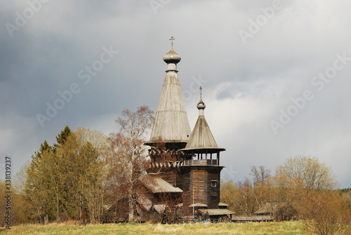 Ancient wooden church of Dmitry Solunsky Myrrh-pouring in the November cloudy evening. Village of Shcheleyki, Leningrad Region, Russia photo