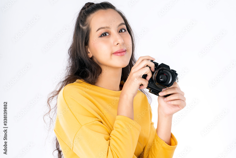 Young beauty Asian woman using camera to take photo and she wearing a yellow sweater shot isolated on white background Young beauty Asian woman using camera to take photo and she wearing a yellow sweater shot isolated on white background