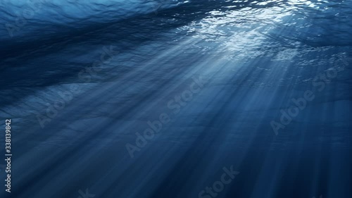 Underwater view with ocean waves flowing in the clear blue water. Beautiful aquatic view with sunbeams shining and creating god rays in the deep sea. 3D animation with swells and tidal waves