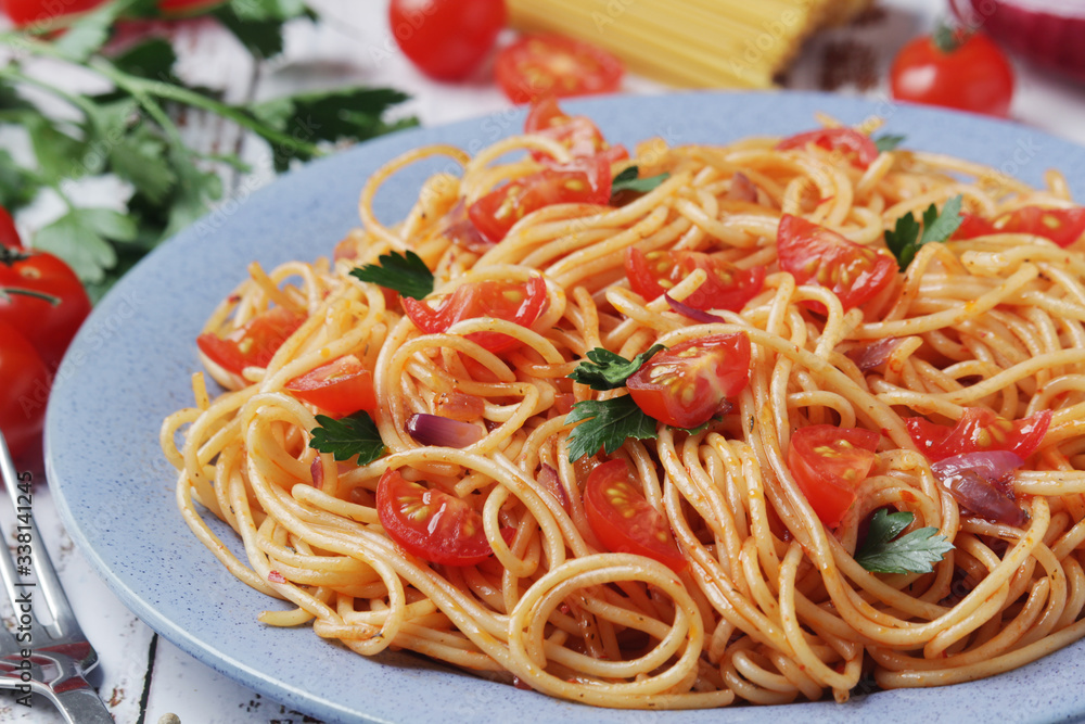 A plate with spaghetti with tomatoes A plate with spaghetti with tomatoes