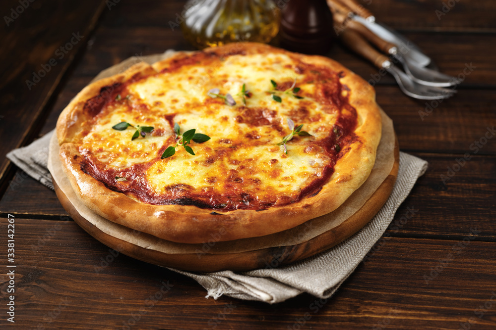 Fresh and appetizing pizza Margherita on dark wooden background Fresh and appetizing pizza Margherita on dark wooden background