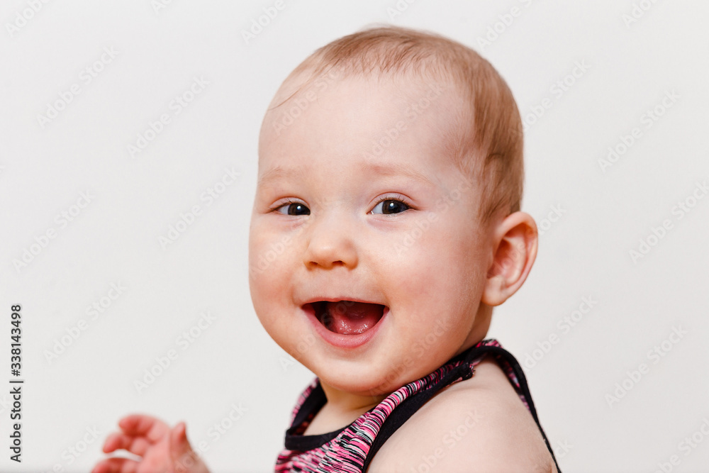 smiling baby girl close up on a white background smiling baby girl close up on a white background