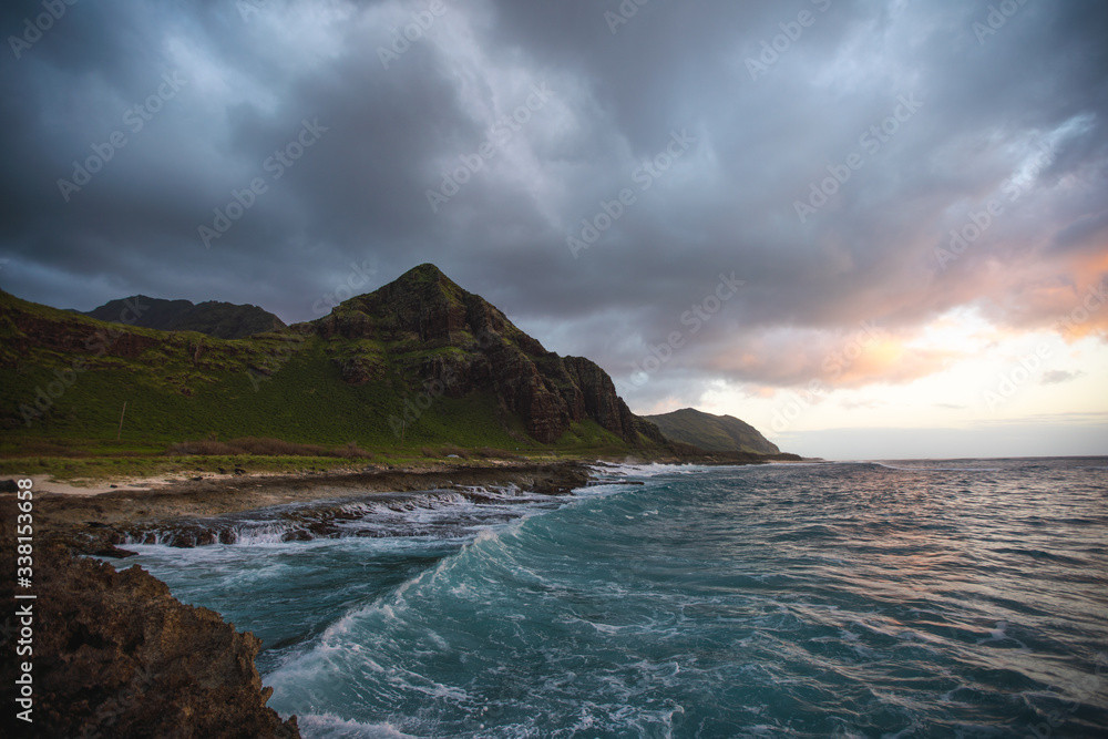 View of coastline by sea during sunset View of coastline by sea during sunset