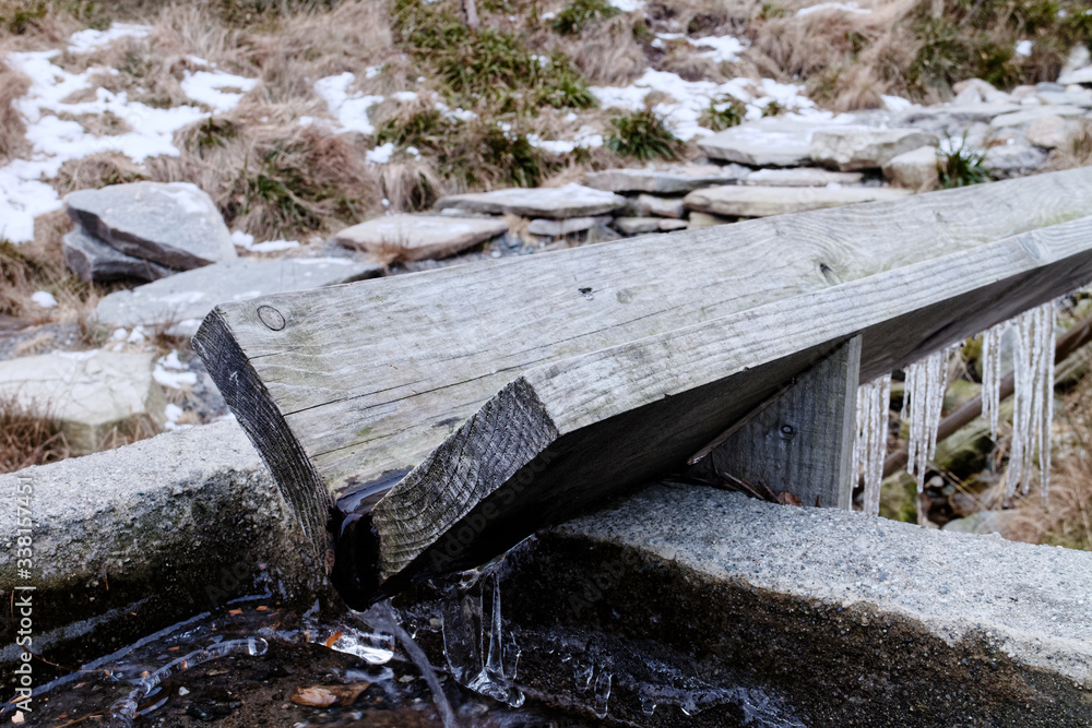 Obraz premium Horse watering gutter, horse watering spring water source on the road to Mr Floyen in the forest near Bergen, Norway, Scandinavia.