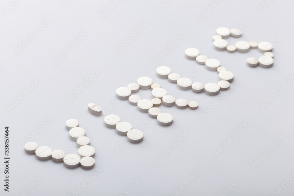 Virus inscription made of round white pills on a white background, medical concept on the theme of the coronavirus strain covid-19 pandemic with copy spce. Virus inscription made of round white pills on a white background, medical concept on the theme of the coronavirus strain covid-19 pandemic with copy spce.