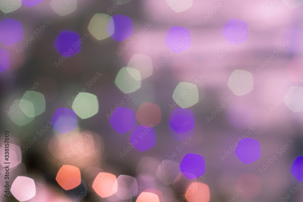 Abstract multi-colored bokeh on a lilac background. Blurred background