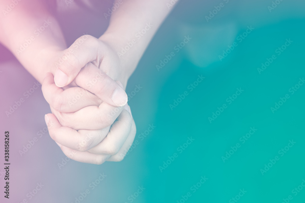 Woman's hand praying and worship to GOD Using hands to pray in religious beliefs and worship christian in the church or in general locations in vintage color tone or copy space. Woman's hand praying and worship to GOD Using hands to pray in religious beliefs and worship christian in the church or in general locations in vintage color tone or copy space.
