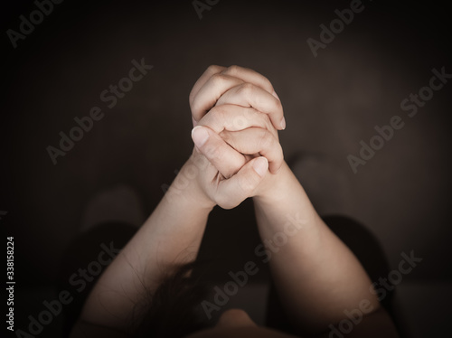 Woman's hand praying and worship to GOD Using hands to pray in religious beliefs and worship christian in the church or in general locations in vintage color tone or copy space.