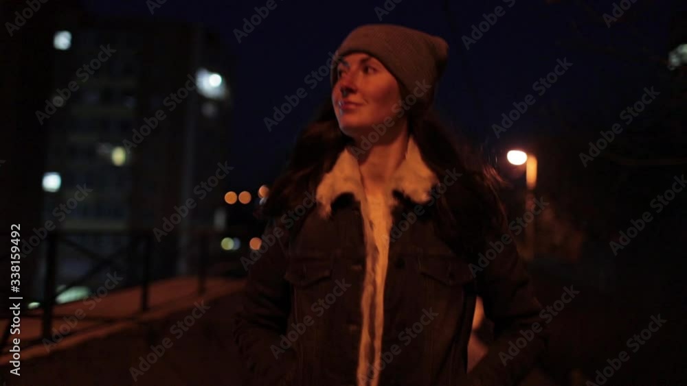 Woman walking alone on an empty city street at night Woman walking alone on an empty city street at night